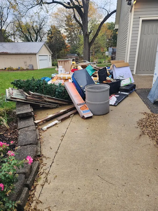 Dumpster being loaded with debris for Roofing Dumpster Rental in Marathon